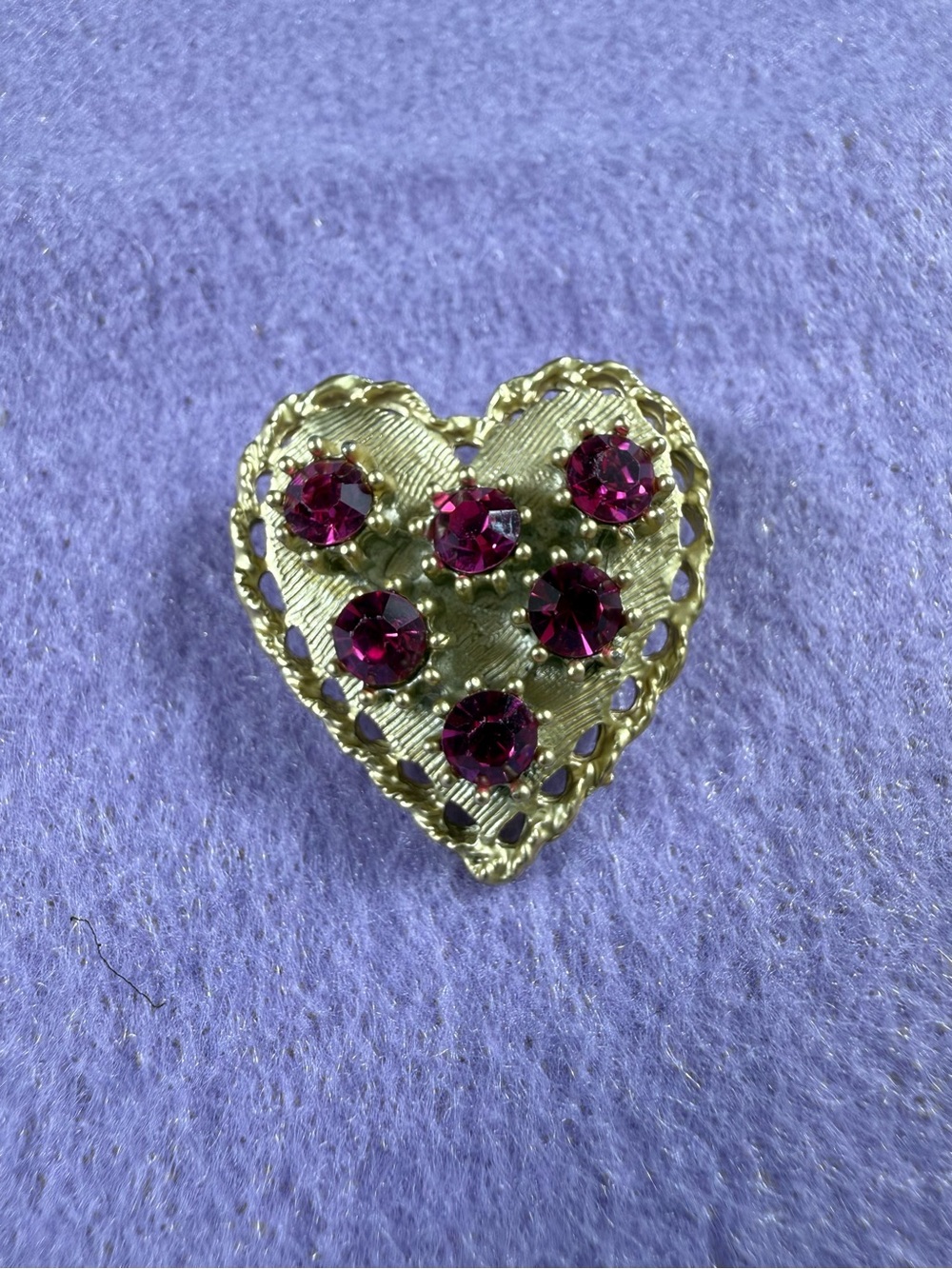 Vintage gold tone heart brooch with pink stones.